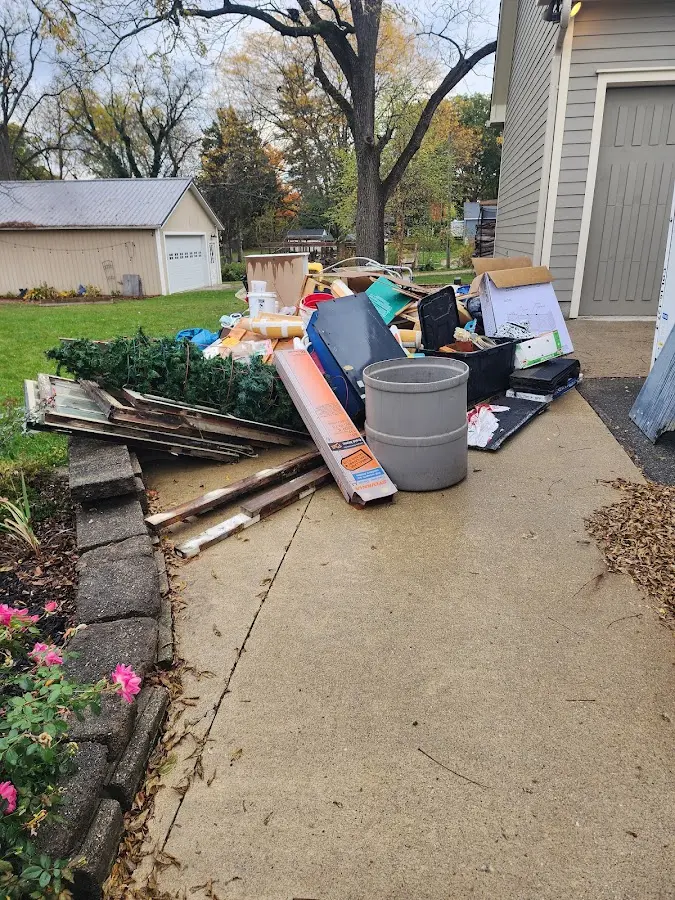 Dumpster being loaded with debris for 30 Yard Dumpster Rental in Peoria Heights